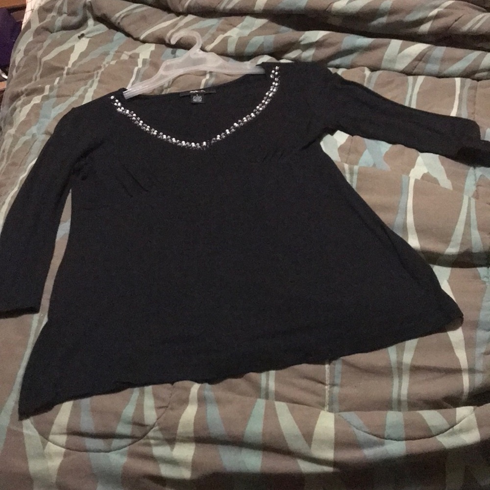 Ladies blouse with embellishments around collar.